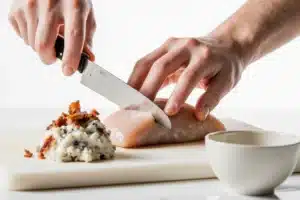 Bacon & Cream Cheese Stuffed Doritos Recipe 11 Cutting chicken breast pocket for cream cheese and bacon stuffed doritos chicken