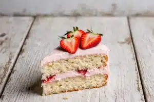 Easy Paula Deen Strawberry Cake Recipe with Creamy Strawberry Frosting 10 Finished layered Paula Deen strawberry cake garnished with fresh strawberries and mint