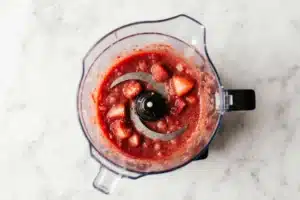 Easy Paula Deen Strawberry Cake Recipe with Creamy Strawberry Frosting 5 Pureed frozen strawberries in a blender for Paula Deen strawberry cake batter and frosting