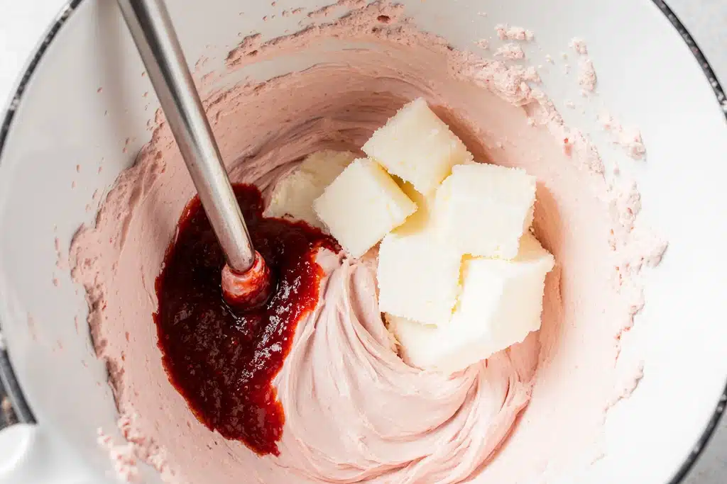 Easy Paula Deen Strawberry Cake Recipe with Creamy Strawberry Frosting 15 Creamy strawberry cream cheese frosting being mixed for Paula Deen strawberry cake