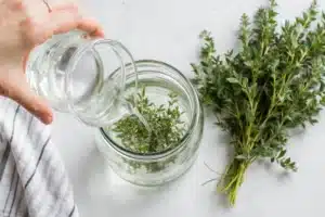 How to Make Effective Homemade Mouthwash Recipe 5 Steeping herbs and measuring water for homemade mouthwash recipe base mixture